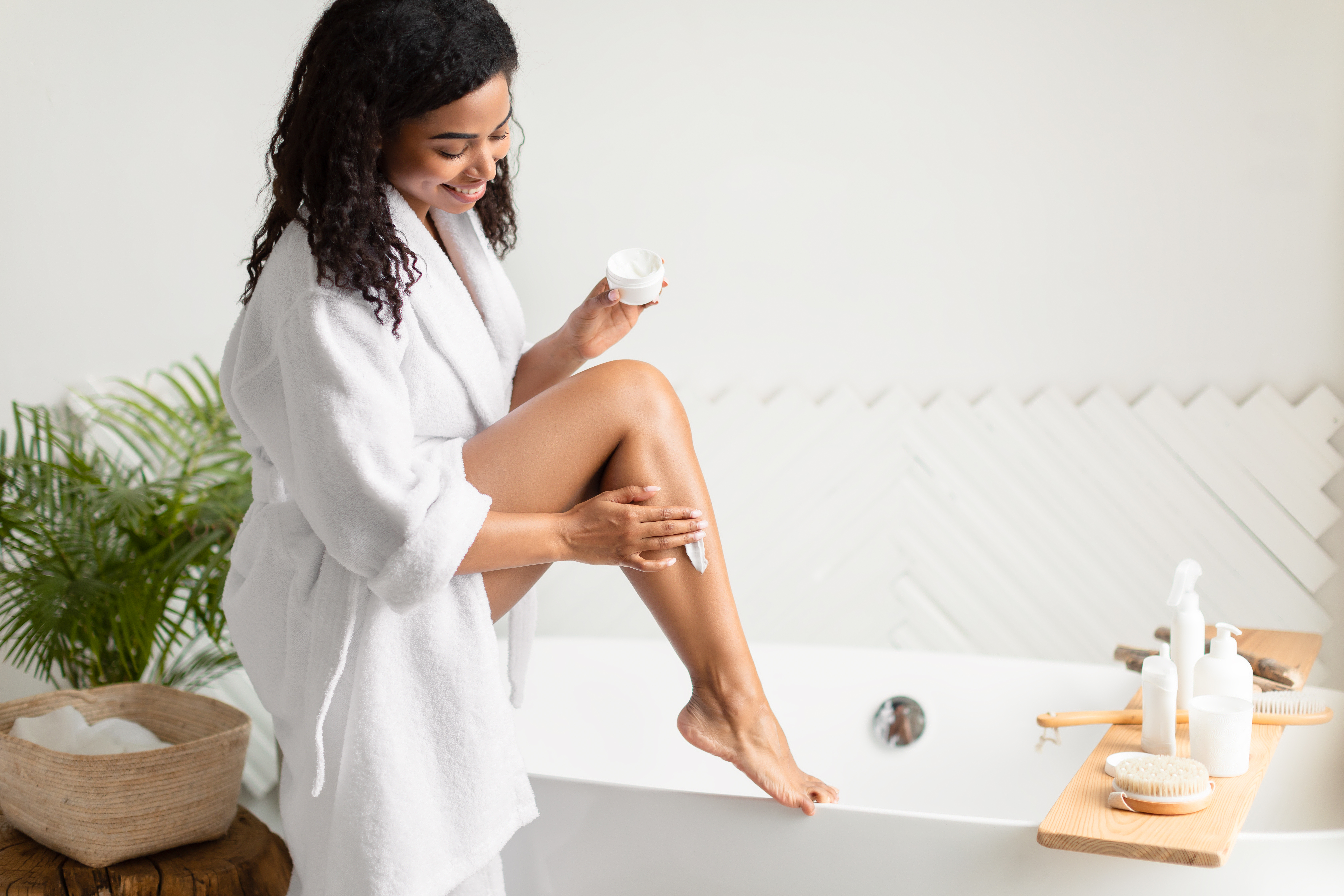 Woman applying moisturizer